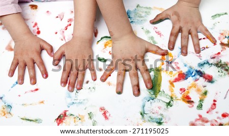 Colorful children hand print on the wallpaper