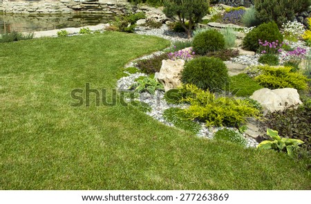 Green lawn in a colorful landscaped formal garden.Detail of a botanical garden