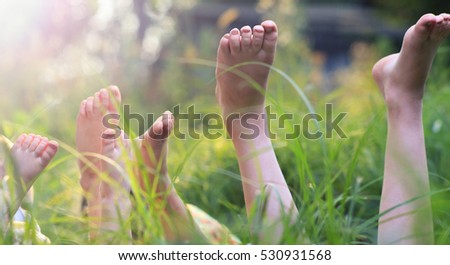 Happy children lying on green grass