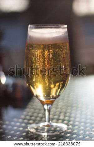A glass of beer in a sunset on a terrace table