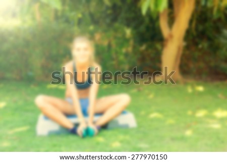 Young woman during her outdoor step workout. Abstract blur background with bokeh, lightly toned