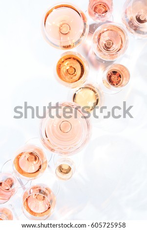 Many glasses of rose wine at wine tasting. Concept of rose wine and variety. White background. Top view, flat lay design. Vertical