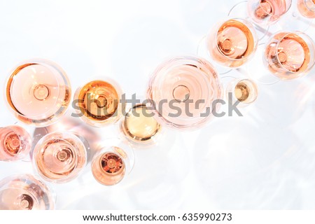 Many glasses of rose wine at wine tasting. Concept of rose wine and variety. White background. Top view, flat lay design. Horizontal