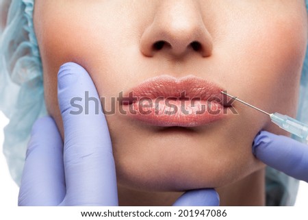 Cosmetic injection to the pretty woman face on white background