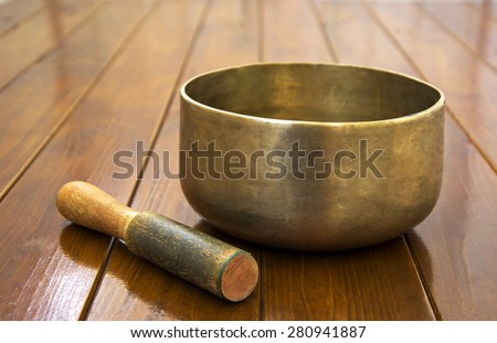 Metal singing bowl on a wooden surface