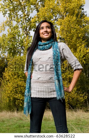Pretty ethnic girl enjoying the fall season.