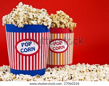 Two popcorn buckets over a red background.