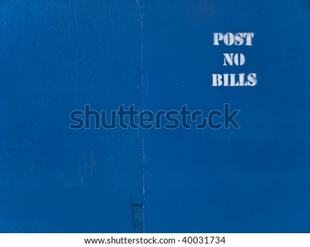 Blue wooden panel background with a white stenciled \