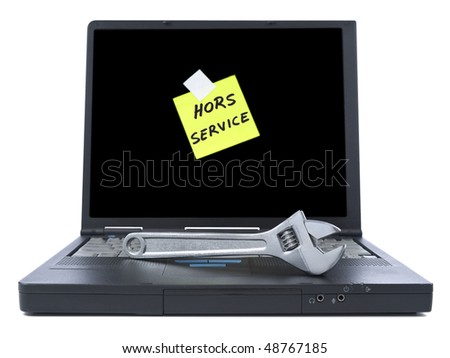 Black laptop with a sticky note in french meaning Out of Service. Isolated on white.