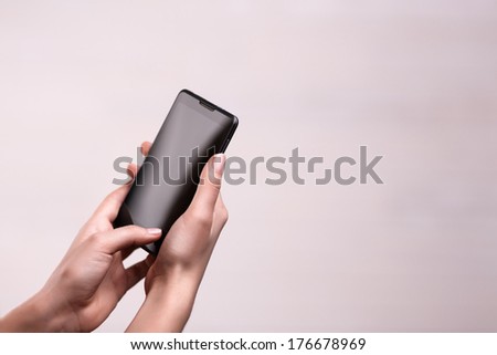 telephone in neat girl's hands, on white background