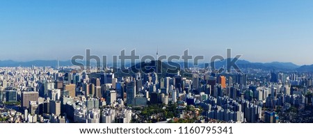 Seoul skyline on a perfect day with a focus on Central Business District while parts of Gangnam Business District and Lotte Tower are visible in a distance.