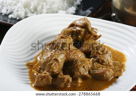 Kerala special kozhi curry - Chicken cooked in a tangy coconut sauce with onion chillies and spices.