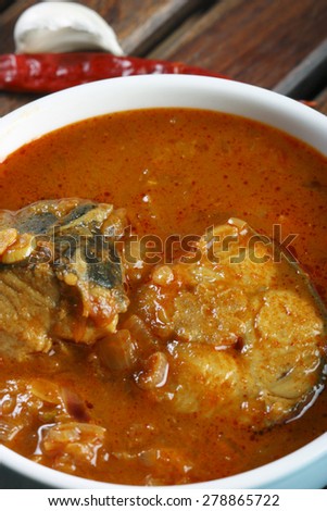 Tilapia fish curry from Kerala, India which is prepared with roasted coconut, red chillies, tomatoes and tamarind and served with rice.