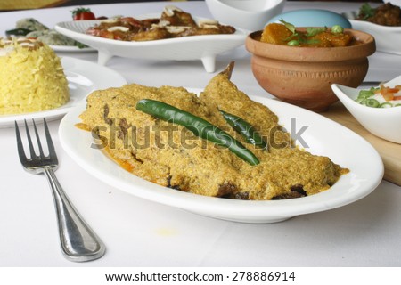 Curd based fish curry in which fish cooked in yogurt based mustard sauce, which is also called as \