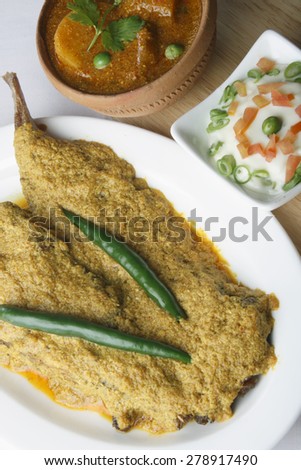 Curd based fish curry in which fish cooked in yogurt based mustard sauce, which is also called as \