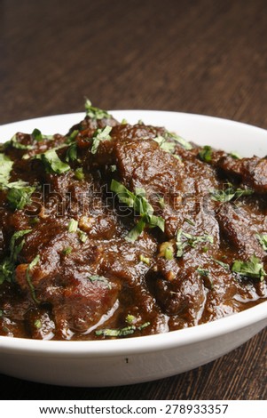kasha mangsho, a curry of goat-meat chunks, mostly boneless, in a rich onion gravy.