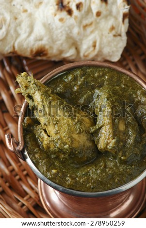 Saag Chicken it contains Chicken, cooked in Palak gravy (Spinach)   with Indian spices. Served with roti (flat Indian bread)