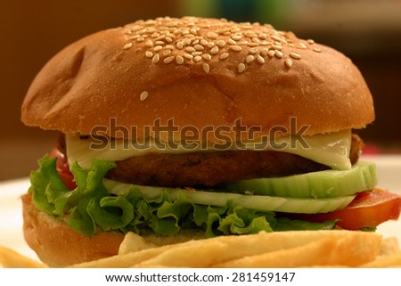 A veggie burger is a hamburger-style which contains vegetables (like corn), textured vegetable (like soy), legumes (beans) etc.