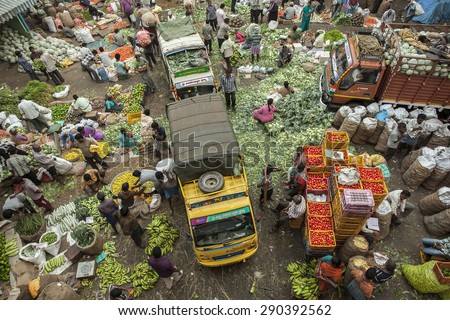 BANGALORE, INDIA - May 27, 2014: Aerial view of the crowded city market, vendors sell vegetables, vehicles move through the crowd
