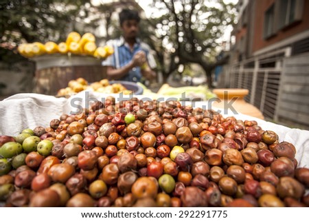 Bangalore, Karnataka, India - November 28, 2014: Street vendor selling sweet corn and jujube fruits on roadsides of bangalore