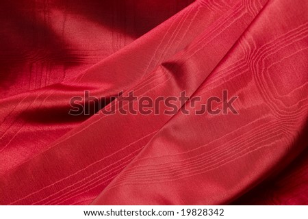 Wrinkled up luxurious red textured satin cloth