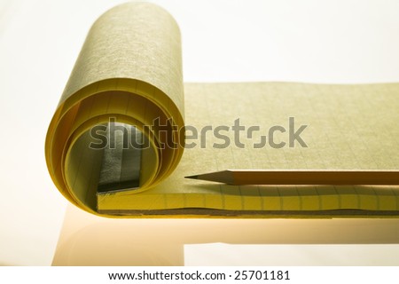 End view of a pad of yellow lined paper