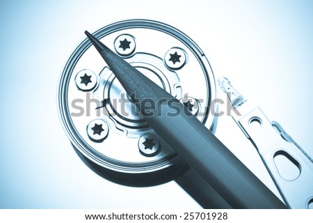Hard drive platter showing read write head and pencil