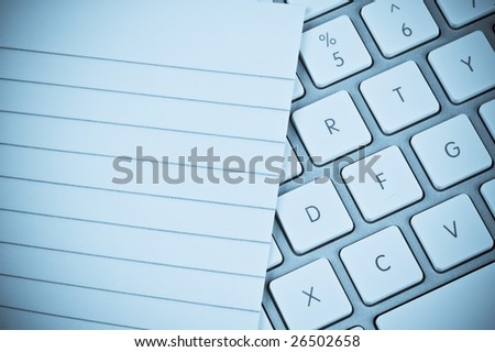 Lined pad of paper and a computer keyboard