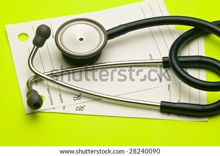 Medical stethoscope and a doctors prescription pad