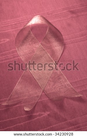 AIDS awareness ribbon isolated against textured satin cloth