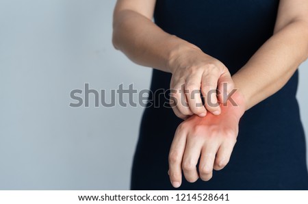 Itching of skin diseases in women using the hand-scratching. Red around the Itching area. Concept with Healthcare And Medicine.