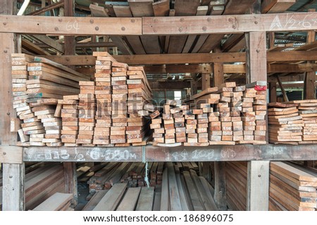 Pile of wood on the floor and on store shelves.