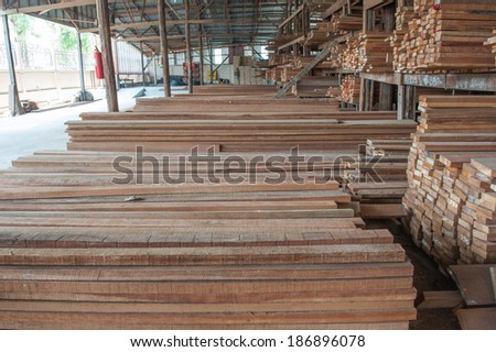 Pile of wood on the floor and on store shelves.