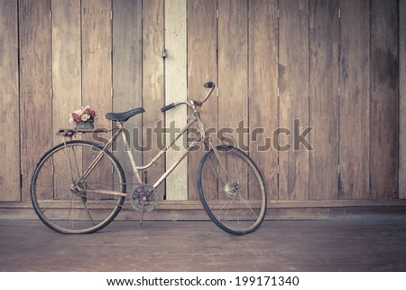 vintage bicycle on wooden house wall