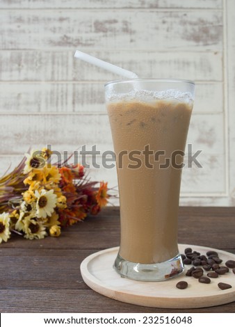 Iced coffee with milk on a wooden table