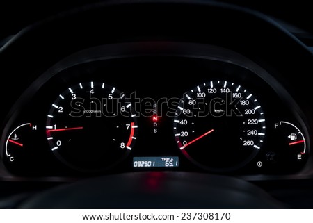 Car Dashboard. Close up image of illuminated car dashboard.