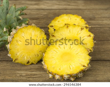 pineapple and pineapple slice on wood table. for health.