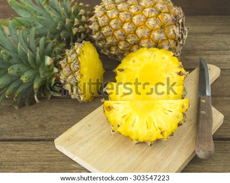 pineapple and pineapple slice on wood table. for health.