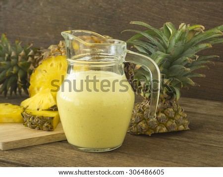 pineapple juice and pineapple slice on wood table. for health.