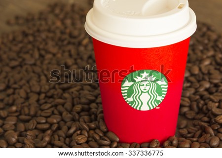 Bangkok, Thailand - November 10, 2015: The new paper cup of Starbucks stores for the Christmas on a red background cup of Starbucks logo. Starbucks brand is one of the world famous from USA.