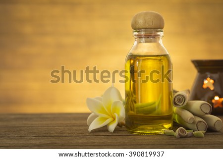Lemon grass essential oil placed on a wooden table. Space for your text. Spa concept.