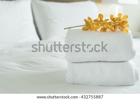 Close up, Fresh white Towel with flowers placed on the inside of the hotel room.