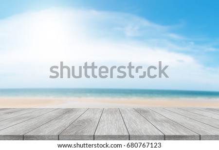Top of the empty wooden table with a summary of beach and sky and natural light of summer. For trade shows and advertising and promotion.