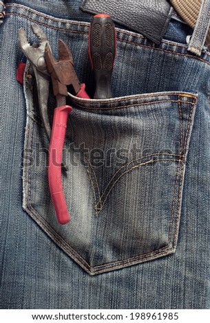Toolkit of five items in a blue jeans pocket