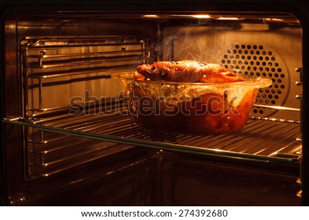 roast chicken in the oven cooking in the oven