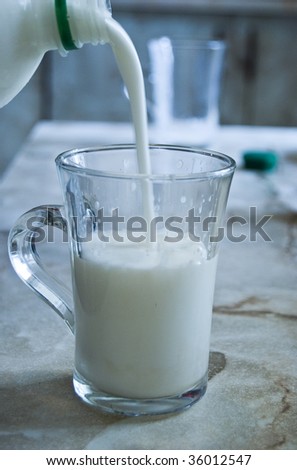 Pouring sour milk in to a glass