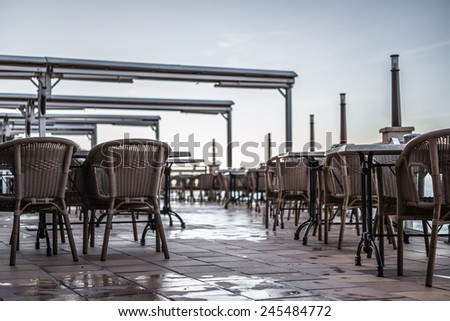 Empty restaurant terrace in summer plashy after rain