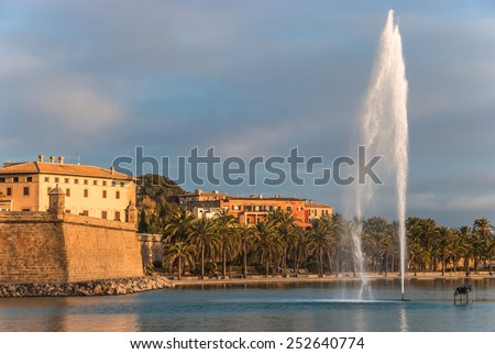 Water Fountain near the Ocean in Parc de la Mar, Palma de Majorca, Balearic Islands, Spain Single Water Fountain at the Ocean Fronting Mediterranean Houses with Beach Trees on the Side.