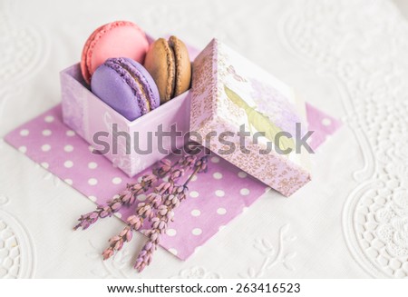 Assorted colorful french macarons in vintage box sweet dessert food \
Delicious biscuit merinque from France in small gift box with lilac lavender on polka dot napkin for bakery business website blog