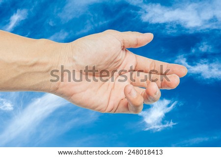 Adult hand reaching out towards the sky